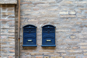 letter boxed on an old building stone brick wall