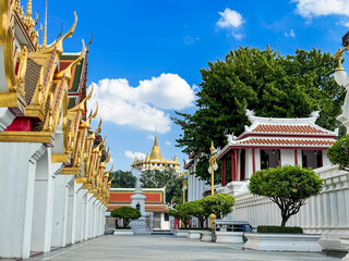A picture of a Thai temple in bright brass color overlooking the Golden Mountain of Wat Saket.
