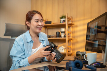 Young photographer working on her photos at her home office