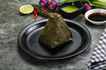 Asian cuisine - rice with filling in banana leaf
