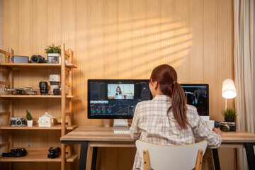 young creative woman working editing video footage in modern home office.