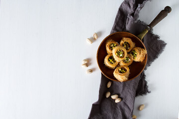 Traditional arabic dessert baklava with pistachios. White background - 712234094