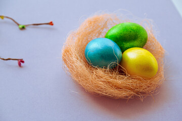 Easter holiday background with colored eggs in nest and space for text. Congratulations with easter, wishes and greetings.
