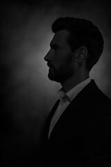 Obraz premium Silhouette of man in darkness. Portrait on black background