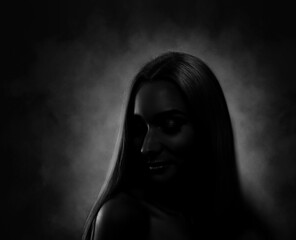 Silhouette of woman in darkness. Portrait on black background