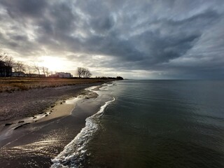 The sun is breaking through clouds at the beach of the Baltic Sea in Lubmin - 712235678