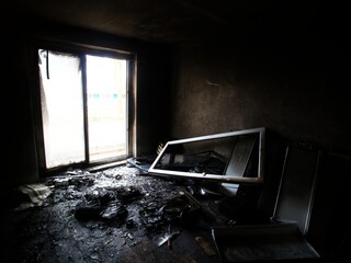 Burnt and destroyed room with bright daylight coming from balcony door - 712235870
