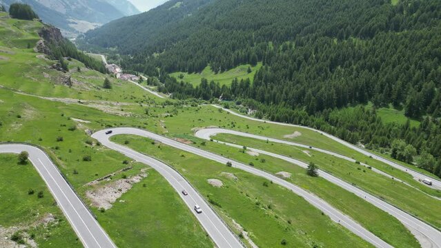 Cars drive Mountain Pass Maddalena in Alps between France and Italy - Aerial 4k High Angle