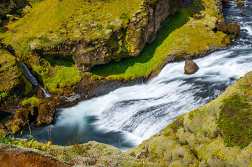 Naklejka na ściany i meble Long exposure view of famous waterfalls of river Skógá. Skógafoss. Magnificent Iceland in august. Fimmvörðuháls Hiking Trail. Popular Travel destinations. 