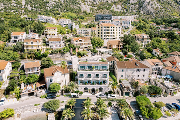 Fototapeta na wymiar Luxurious Forza Terra hotel next to ancient villas. Dobrota, Montenegro. Drone