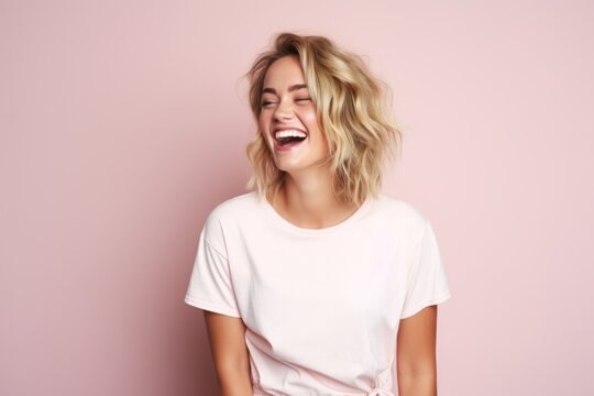 A young blonde woman laughing portrait, pink background web banner 