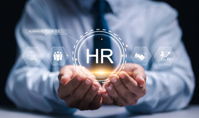 Human Resources HR management concept. Businessman hold virtual HR word for recruitment process to...