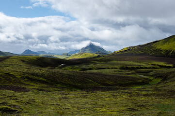 Amazing Icelandic landscape with mountains and field on a sunny day at famous Laugavegur hiking trail, South Iceland. Acid colours landscape.