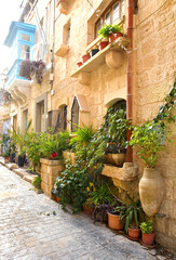 Fototapeta na wymiar Narrow historical street in downtown of Rabat, Malta 