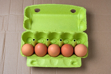 Chicken eggs in a paper cardboard cage