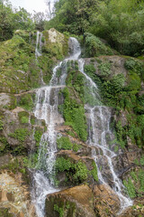 Fototapeta na wymiar Beautiful cascading Bakthang waterfall in the Himalayan valley in Sikkim, India