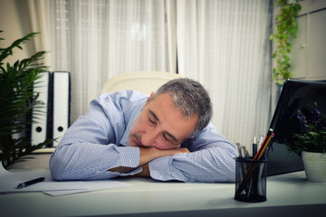 Detail of a man sleeping on an office table