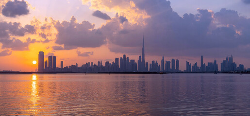 panoramic sunset view of Dubai Downtown cityline from Dubai Creek Canal