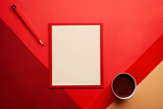 A blank sheet of paper in a red frame in the center of the frame for writing text on a red background, next to a pencil and a glass of coffee.Valentine's day,Birthday,Women's day, Flat lay, copy space