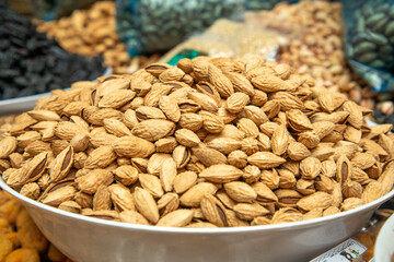 dried almond in a big jar for sale in the market