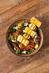 Delicious salad added to grilled dishes, with bacon and halloumi cheese.