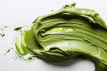 Obraz premium Exfoliating scrub with green clay and natural ingredients Beauty mask applied on white background Cosmetic product close up