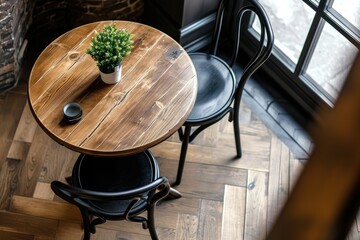 Top view of indoor wooden table and black chair