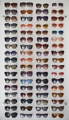 Assorted styles of tinted sunglasses on white background