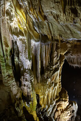 The cave is karst, amazing view of stalactites and stalagnites illuminated by bright light, a beautiful natural attraction in a tourist place.