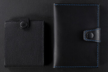 Black leather wallet on a black background.