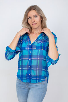 Beautiful middle-aged blonde woman with a slim figure in casual clothes, shirt and jeans