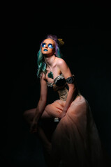 Woman With Green Hair and Blue Eyes Sitting on Chair