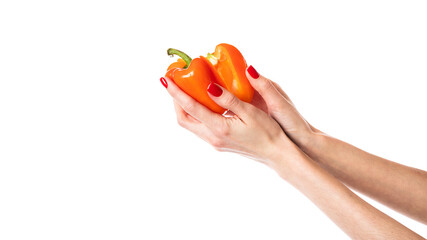 Orange sweet bell pepper in hand isolated on a white background. Woman holding bulgarian pepper.Chopped pepper. Half of pepper.