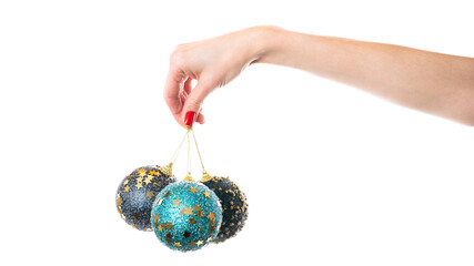 Woman's hand holding decorative Christmas ball over the white wall. Isolated on white background.