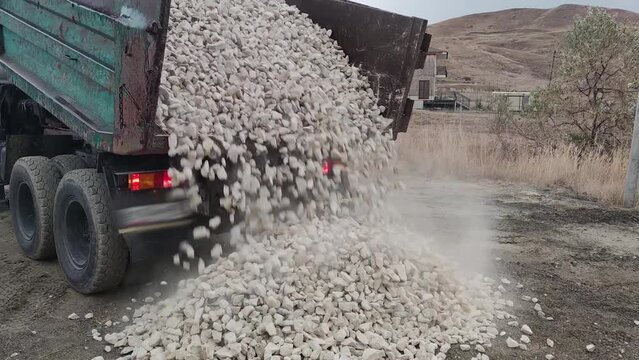 Unloading a large quantity of gravel from a dump truck