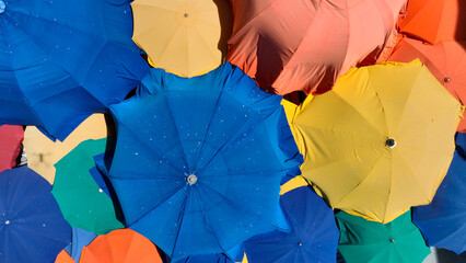 Aerial view of colorful umbrellas on Italian city street food market 