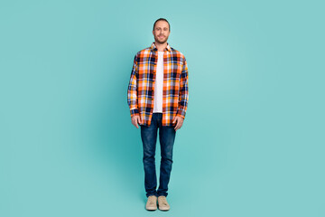 Full length photo of confident stylish good mood man wear flannel shirt jeans pants standing isolated on turquoise color background - obrazy, fototapety, plakaty
