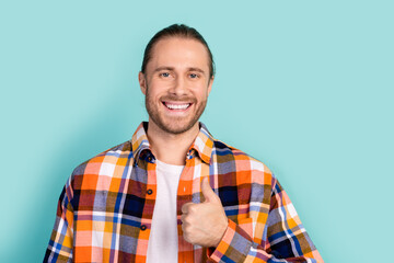 Portrait of toothy beaming positive man with stubble wear flannel plaid jacket showing thumb up...