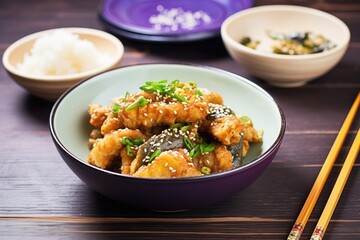 eggplant tempura halves by a bowl of teriyaki