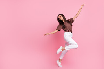 Full body profile photo of pretty positive lady raise hands good mood dance empty space isolated on...