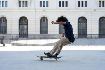 Skater sliding on board in the street.