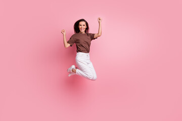Full body length photo of energetic lady jumping raised fists up celebrating her awesome...