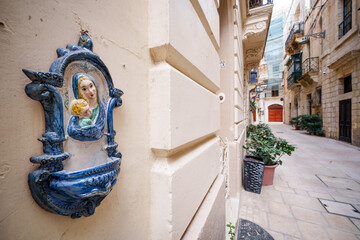 Religious Virgin Mary figure on a house wall