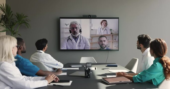 Diverse group of doctors talking to remote colleagues on Internet video conference call, discussing medical expertise issues, consulting healthcare expert, disease diagnosis specialists
