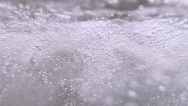 Woman Relax in a Hydromassage Pool with Bubbles and Making a Heart Shape Underwater in Switzerland.