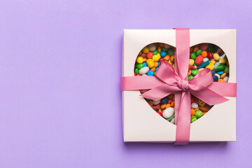 Box with sweet chocolate candies on color background, Various candy sweets. Valentines day gift box. Top view flat lay with copy space