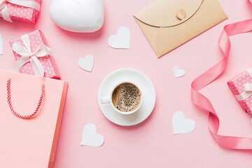 Mug coffee and gift box on colored background. Flat lay composition. Holiday concept