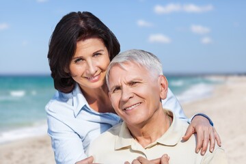 Obraz premium Happy senior couple have fun at the beach at vacation