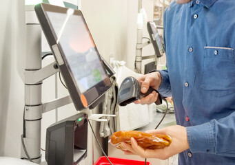 Customer pays his purchase at the supermarket,self checkout systems in  retail stores,Barcode scanner,Self checkout machine