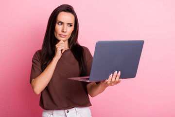 Photo of young funny business woman touch chin when brainstorm ponder look at laptop serious...